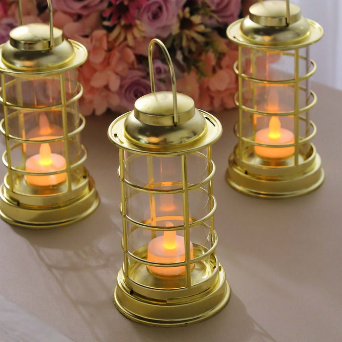 Gold lanterns with LED candles, perfect for ambiance or decor.