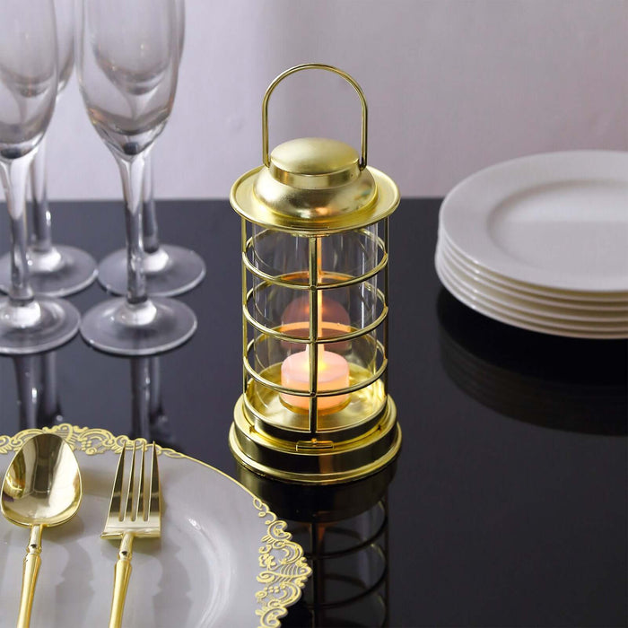 Gold lantern candle holder on a dining table with elegant cutlery and glassware.
