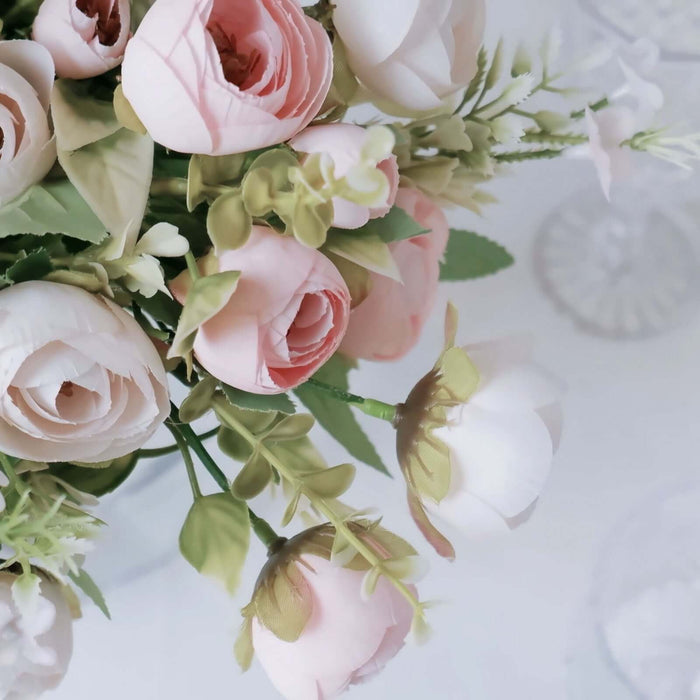 Pink and white artificial flowers in a decorative arrangement.