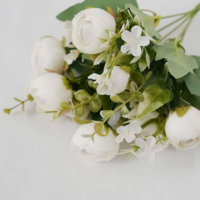 White artificial flower bouquet on a plain background