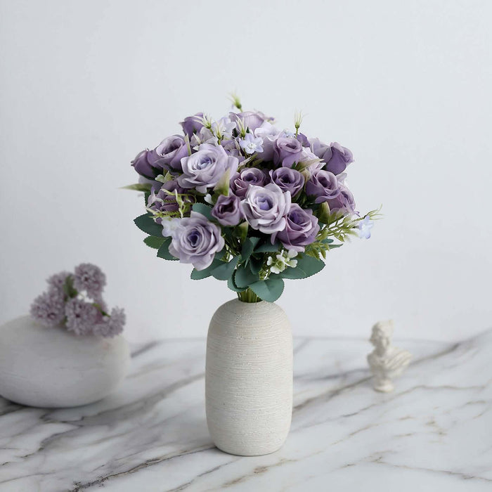 Purple rose bouquet in a minimalist vase on a marble surface.