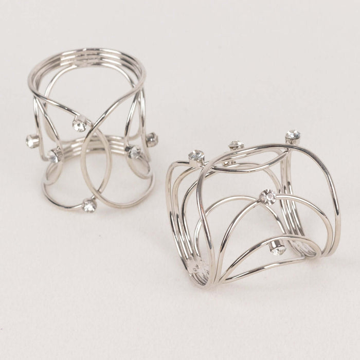 Silver wire rings with decorative stones on a plain background.
