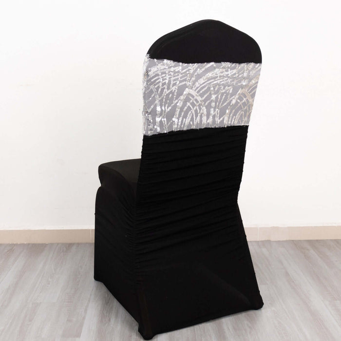 Elegant black chair cover with silver sequined top, studio shot.