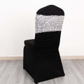 Elegant black chair cover with silver sequined top, studio shot.