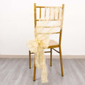 Gold chiavari chair with cream organza sash tied in a bow.