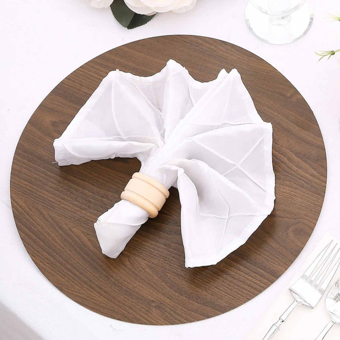 White napkin shaped like an umbrella on a wooden plate.