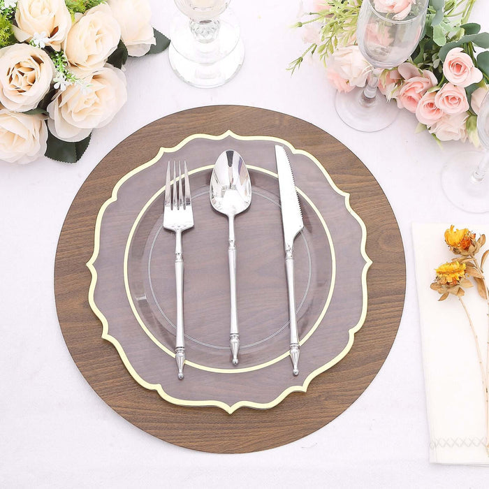 Elegant dining set with decorative plate, silverware, and floral arrangement.