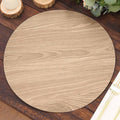 Round wooden placemat in light wood finish on a rustic table.