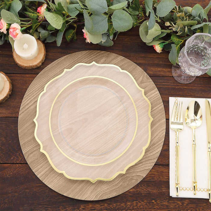 Elegant clear plate with gold trim on wooden table setting.