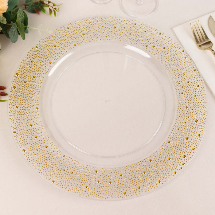 Clear plate with gold polka dot border on a white background.