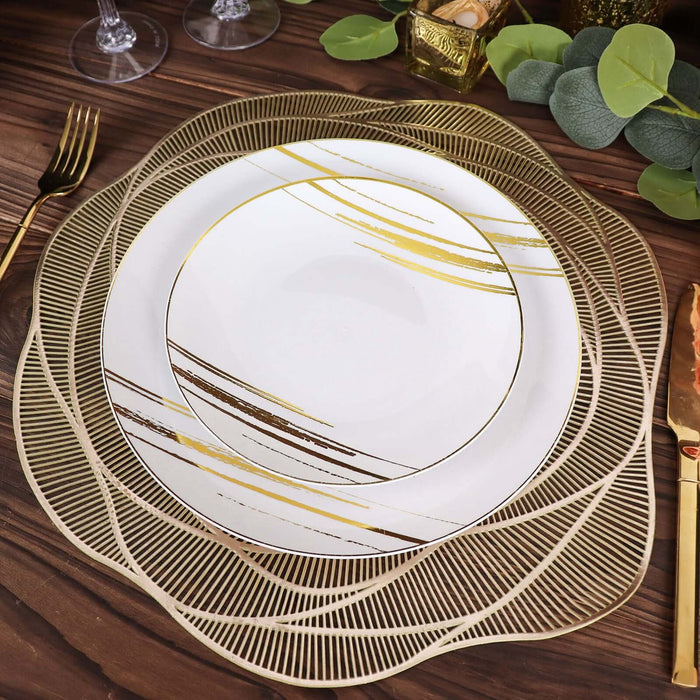 Elegant gold and white dinner plate set on a wooden table.