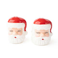Pair of red and white ceramic Santa Claus salt and pepper shakers with closed eyes and festive design.