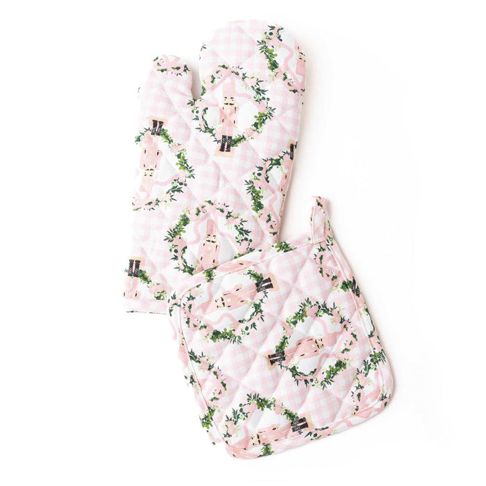 Sugarplum Gingham oven mitt set with pink gingham, nutcracker, and holly leaf pattern on white background
