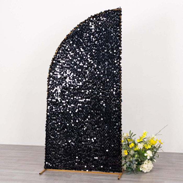 Black sequin backdrop with a curved design and floral arrangement
