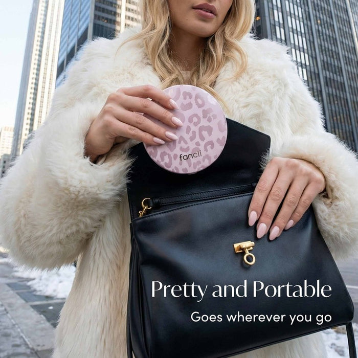 FANCII Taylor LED compact mirror in cosmic leopard pink held by woman in white fur coat