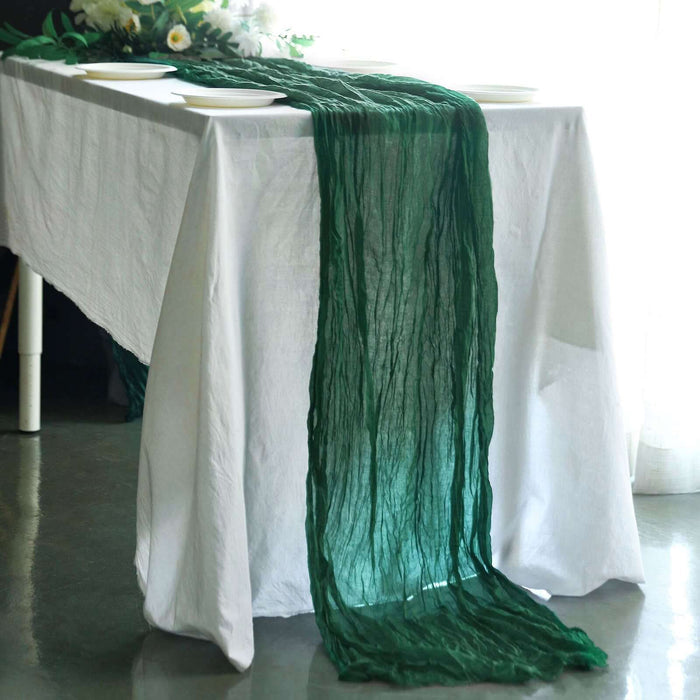 Green textured table runner draped over a white table setting.
