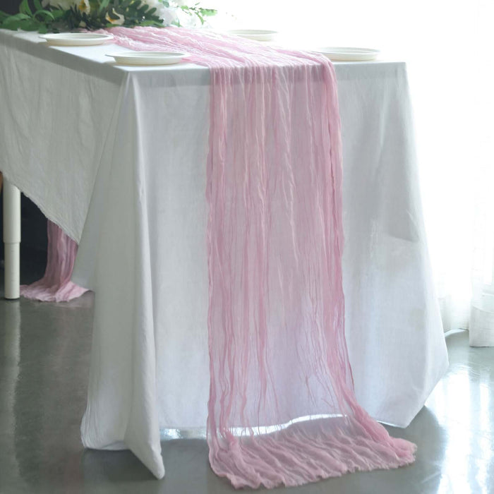 Pink table runner draped elegantly over a white table.