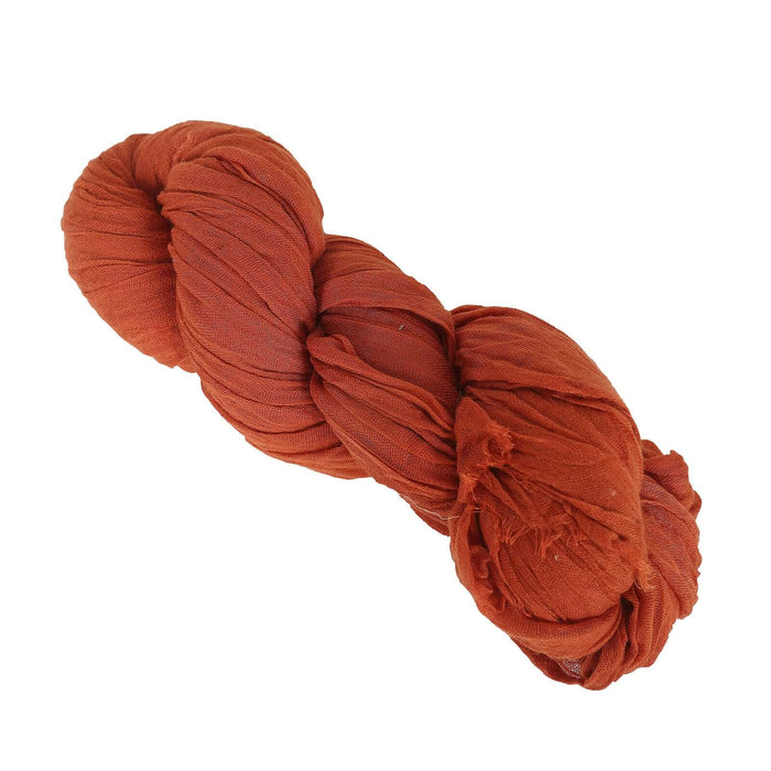 Rust-colored fabric yarn bundle on a white background