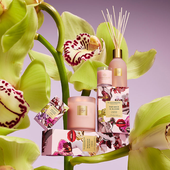 Cosmetic products with orchids on a purple background