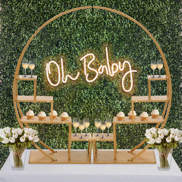 Baby shower dessert display with "Oh Baby" neon sign and floral accents.