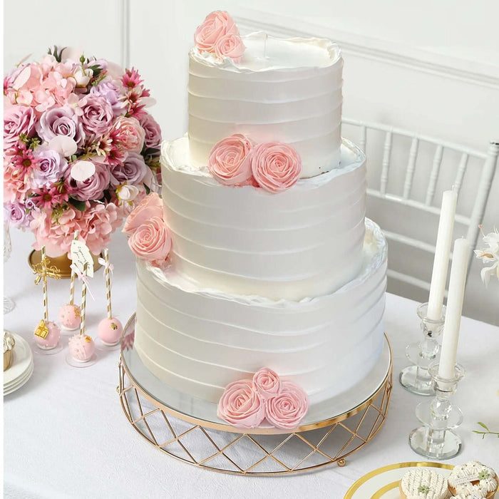 Elegant three-tier wedding cake adorned with pink roses and a charming floral arrangement.