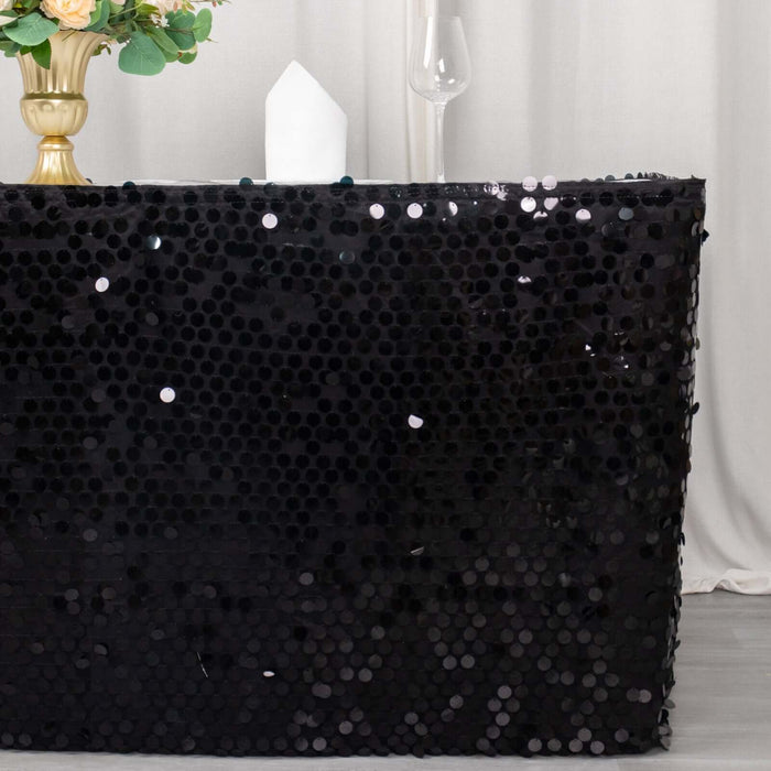 Black sequin table cover with a shiny texture displayed in a staged setting.
