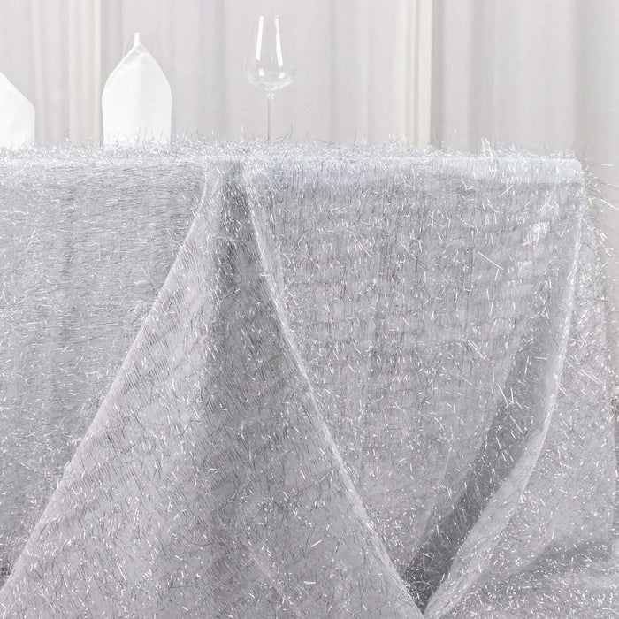 Sparkling silver tablecloth draped elegantly for an upscale dining setting.