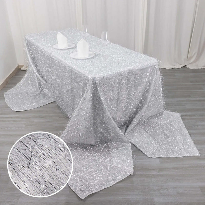 Silver textured tablecloth with elegant drape and setting.