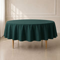 Hunter emerald green round tablecloth on a table.