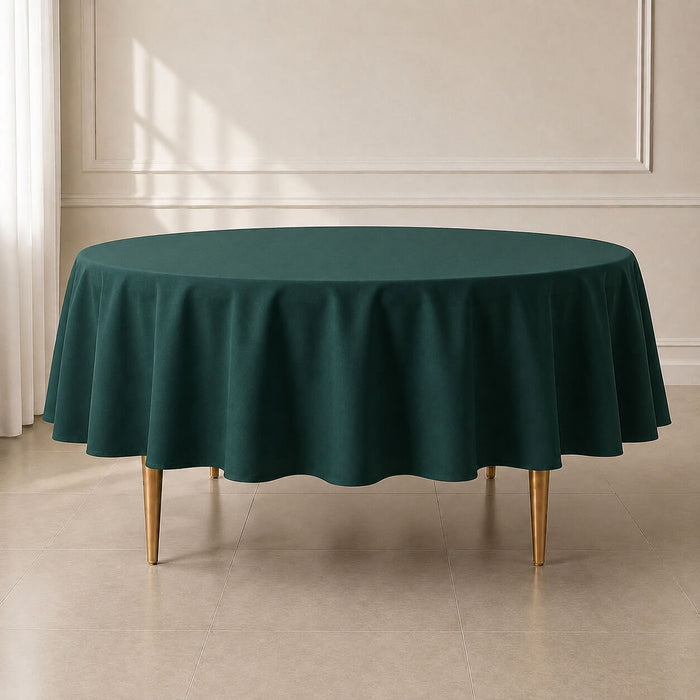 Hunter emerald green round tablecloth on a table.