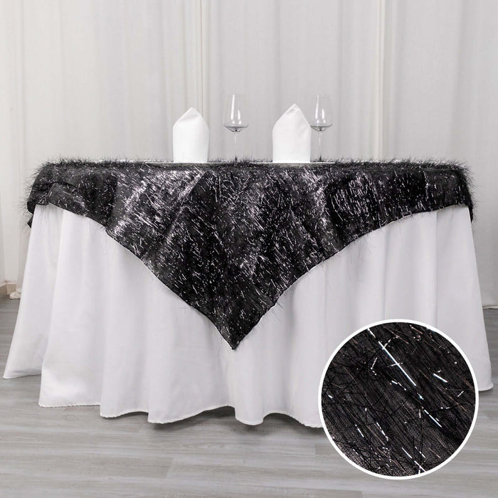 Black table runner on a white tablecloth with glasses and napkins.