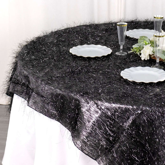 Black tablecloth with textured fringe for elegant dining settings.