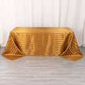 Gold striped tablecloth on a table, elegantly draped.