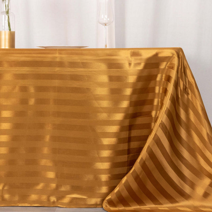 Gold striped tablecloth draped elegantly on a table.