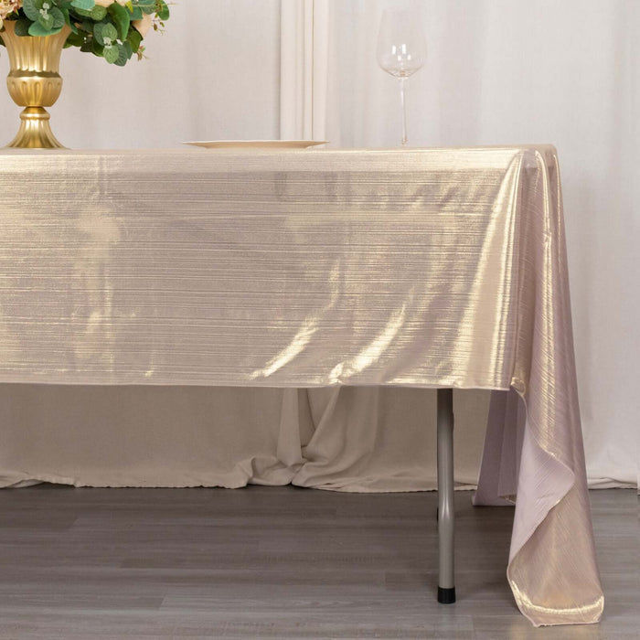 Elegant tablecloth draped over a table with a glass and decorative vase.