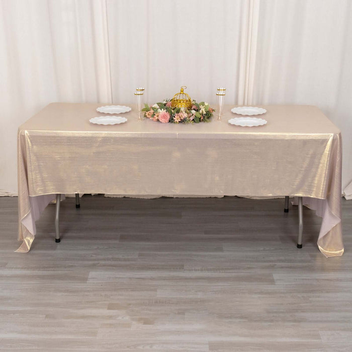 Elegant banquet table with gold cloth and floral centerpiece.