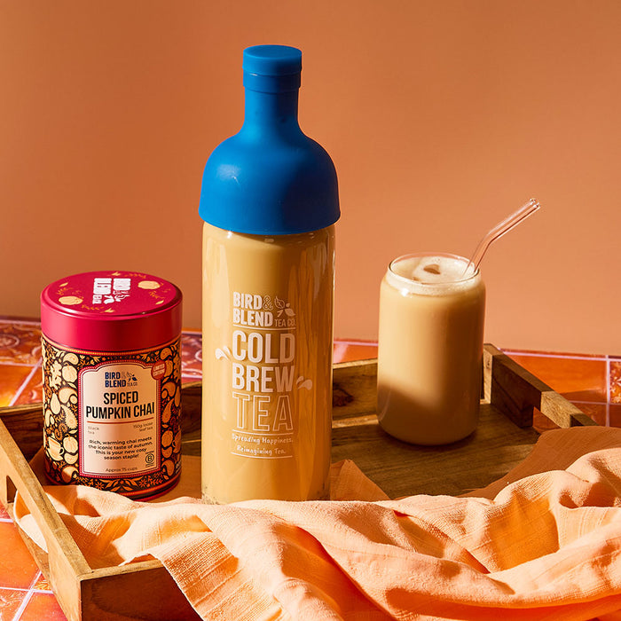 spiced pumpkin chai 150g tin & sapphire blue cold brew tea bottle filled with chai & iced chai latte