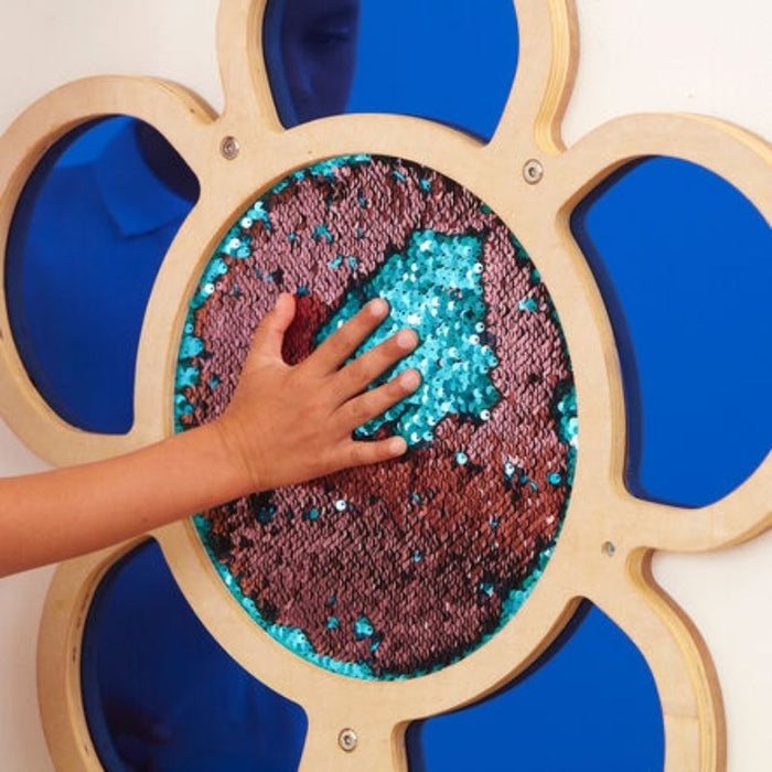 Hand interacting with TTS blue Mark Making Sequin Daisy Frame, showing mermaid sequin texture and tactile sensory engagement - fine motor sensory wall panel