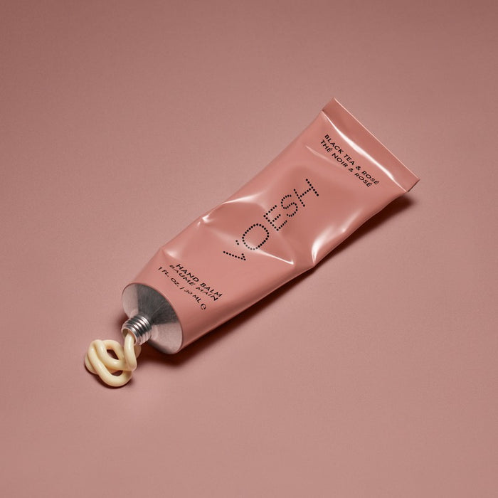 VOESH NEW YORK Black Tea & Rosé Hand Balm 1 oz tube with cream texture swatch on pink background